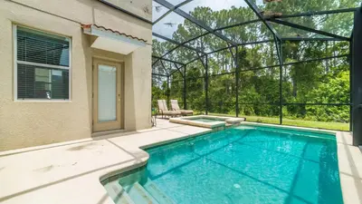 a swimming pool in the backyard of a house at 2979 Buccaneer Palm in Kissimmee