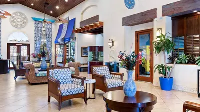 a lobby of a hotel with chairs and tables at 2979 Buccaneer Palm in Kissimmee