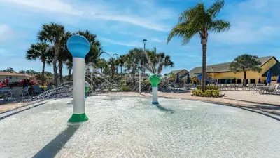 a pool of water with two white and blue poles at 8959 California Palm in Kissimmee