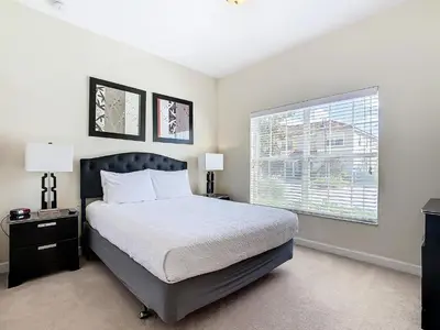 a bedroom with a large bed and a window at 8967 California Palm in Kissimmee