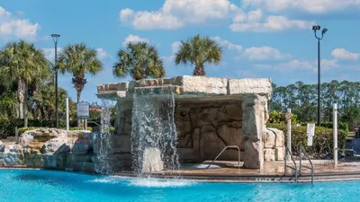 a water fountain in a swimming pool in a resort at 8967 California Palm in Kissimmee