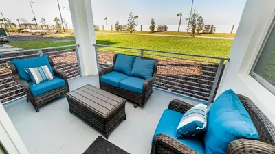 a porch with chairs and a couch and a table at 4741 Clock Tower #102 in Kissimmee