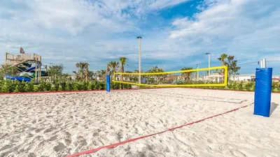 a volleyball court with a volleyball net on a sandy beach at 4741 Clock Tower #102 in Kissimmee