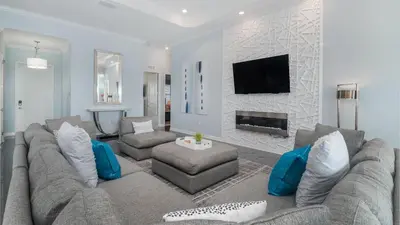 a living room with a couch and a fireplace at 4751 Clock Tower #401 in Kissimmee