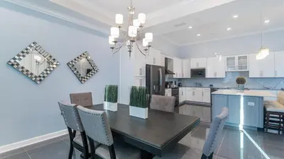 a kitchen and dining room with a table and chairs at 4751 Clock Tower #401 in Kissimmee