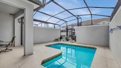 an indoor swimming pool with a glass roof at 3070 Gatsby in Kissimmee