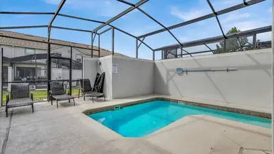 a swimming pool in a house with a glass roof at 3070 Gatsby in Kissimmee