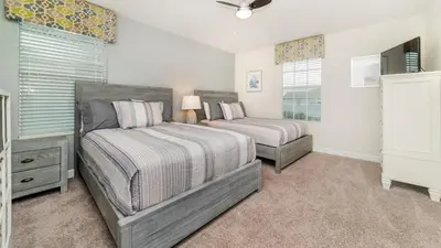 a bedroom with two beds and a window at 4749 Kings Castle in Kissimmee