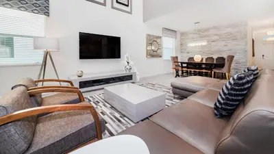 a living room with a couch and a tv at 4749 Kings Castle in Kissimmee