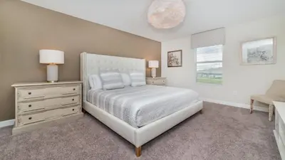 a bedroom with a bed and a dresser and a window at 4749 Kings Castle in Kissimmee