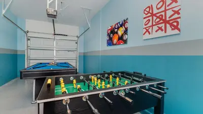 a ping pong table in a room with a pool table at 4797 Kings Castle in Kissimmee