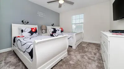 two beds in a bedroom with white walls at 4837 Lullaby in Kissimmee