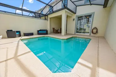 a swimming pool in the middle of a house at 4837 Lullaby in Kissimmee