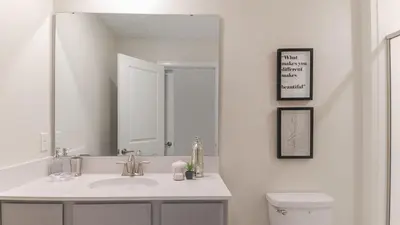 a white bathroom with a sink and a mirror at 4543 Narrative in Kissimmee