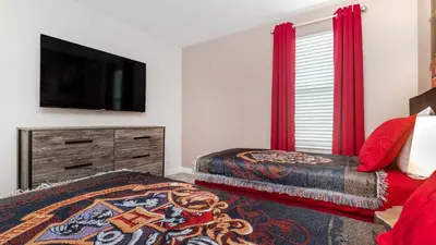 a bedroom with two beds and a flat screen tv at 4543 Narrative in Kissimmee