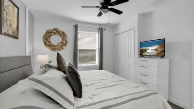 a bedroom with a bed and a ceiling fan at 2718 Oxymoron in Kissimmee