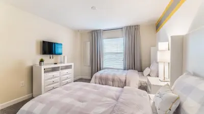 a bedroom with two beds and a tv at 3141 Pequod in Kissimmee