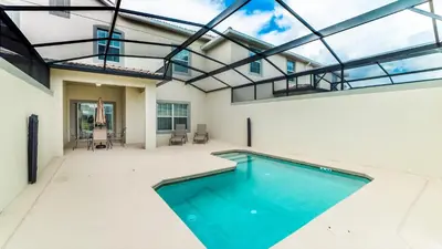 a swimming pool in the middle of a house with glass ceilings at 3141 Pequod in Kissimmee