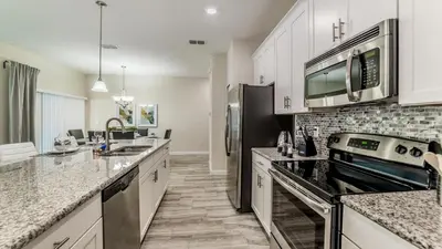 a kitchen with stainless steel appliances and granite counter tops at 3141 Pequod in Kissimmee