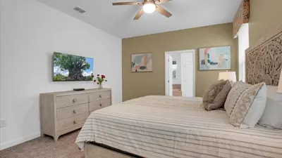 a bedroom with a bed and a ceiling fan at 4169 Paragraph in Kissimmee