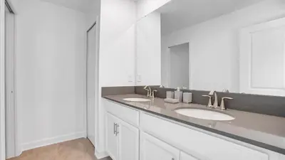 a bathroom with two sinks and a large mirror at 4169 Paragraph in Kissimmee