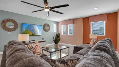 a living room with a couch and a ceiling fan at 4169 Paragraph in Kissimmee