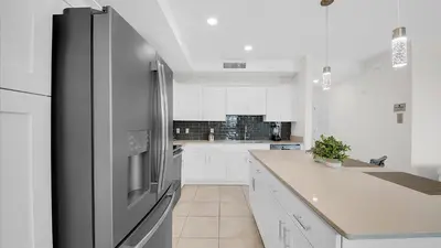 a large kitchen with a stainless steel refrigerator at 3111 Paradox #202 in Kissimmee