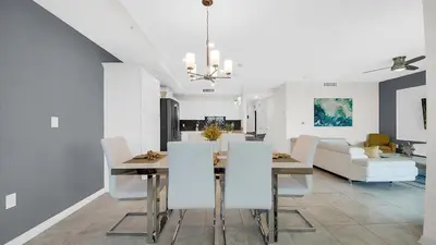 a dining room and living room with a table and chairs at 3111 Paradox #202 in Kissimmee