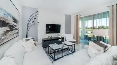 a living room with a white couch and a tv at 3151 Paradox #102 in Kissimmee