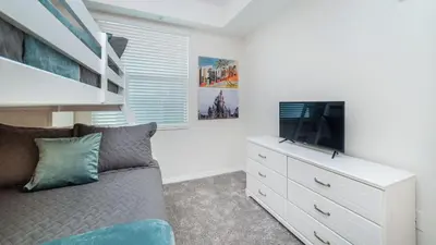 a living room with a couch and a flat screen tv at 3151 Paradox #102 in Kissimmee