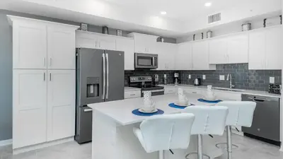 a white kitchen with white cabinets and white appliances at 3151 Paradox #102 in Kissimmee