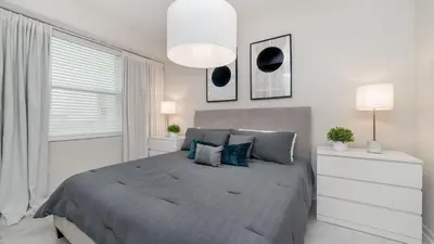 a bedroom with a bed and a large window at 3180 Paradox #303 in Kissimmee