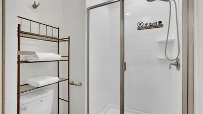 a bathroom with a shower and a toilet with towels at 4361 Quote in Kissimmee