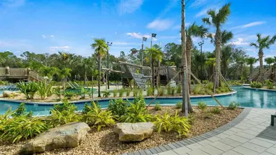 a pool at a resort with a slide at 4361 Quote in Kissimmee