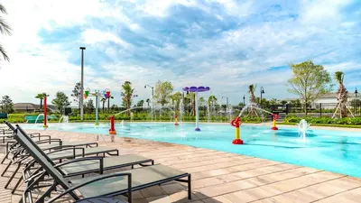 a swimming pool with chairs and a water park at 4361 Quote in Kissimmee