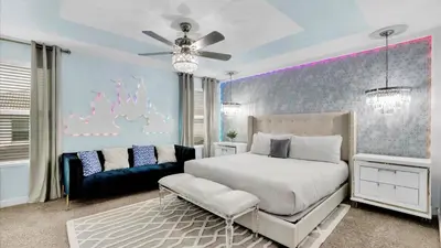 a bedroom with a white bed and a couch at 4720 Sleepy Hollow in Kissimmee
