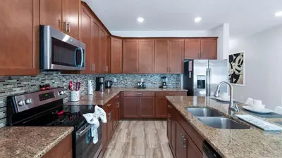 a kitchen with wooden cabinets and stainless steel appliances at 4720 Sleepy Hollow in Kissimmee