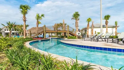 a swimming pool with palm trees in a resort at 4724 Sleepy Hollow in Kissimmee