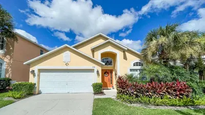 a house with a garage and palm trees at 2787 Lido Key in Kissimmee