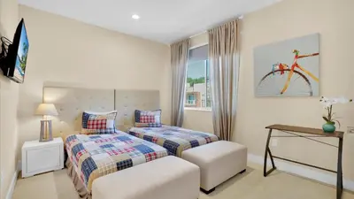 a bedroom with two beds and a bicycle on the wall at 7646 Recife in Kissimmee