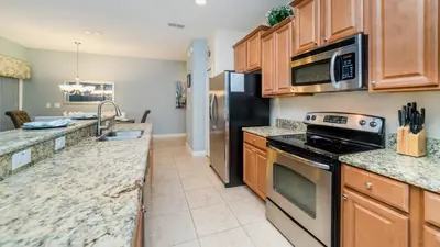 a kitchen with stainless steel appliances and granite counter tops at 8875 Candy Palm in Kissimmee