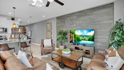 a living room with a flat screen tv on a wall at 2147 Cooper Bell in Kissimmee