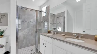 a bathroom with two sinks and a shower at 2147 Cooper Bell in Kissimmee