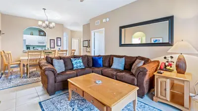 a living room with a brown couch and a table at 7654 Comrow #403 in Kissimmee