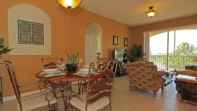 a dining room with a table and chairs at 7660 Comrow #303 in Kissimmee