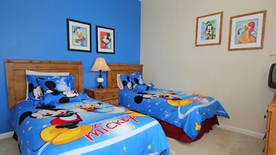 a bedroom with two beds with disney characters on them at 7660 Comrow #303 in Kissimmee
