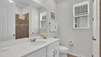 a white bathroom with a sink and a toilet at 1840 Caribbean View in Kissimmee
