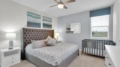 a bedroom with a bed and a crib at 1840 Caribbean View in Kissimmee