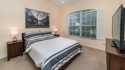 a bedroom with a bed and a flat screen tv at 7705 Comrow in Kissimmee