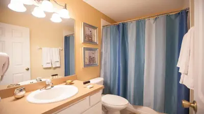 a bathroom with a sink and a toilet and a shower at 7713 Comrow in Kissimmee
